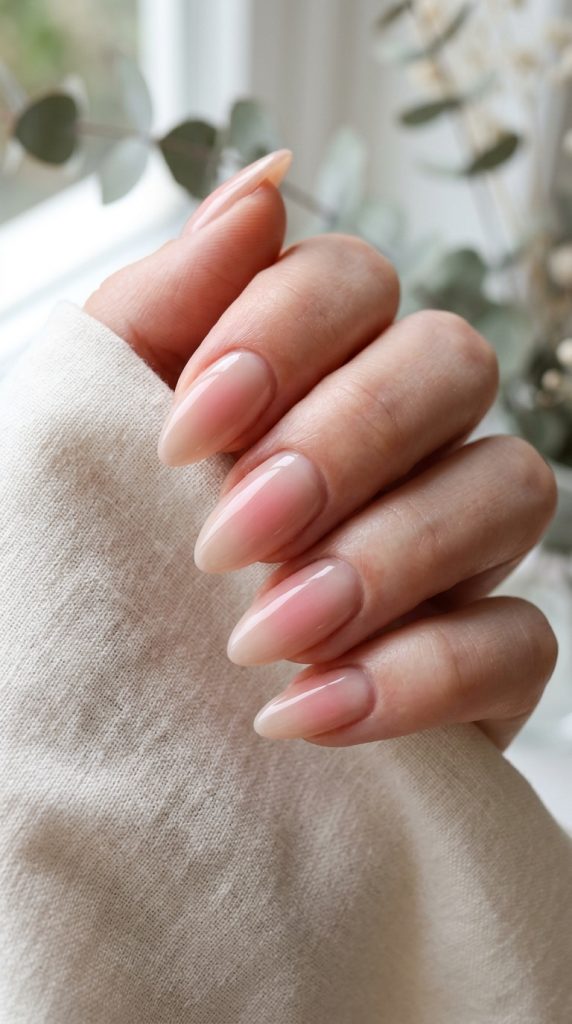 Blush pink aura nails glowing from the center over a nude base