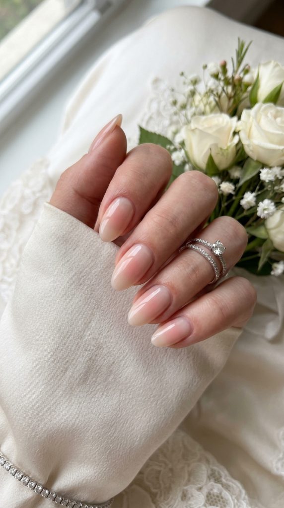 Subtle nude aura nails with a barely-there rose glow