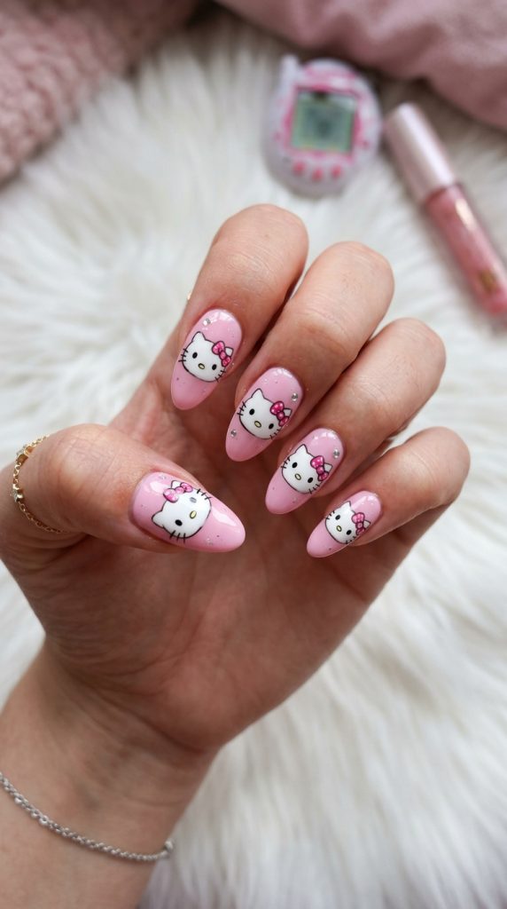 Cute Y2K nails with a cartoon kitten and bow on pink