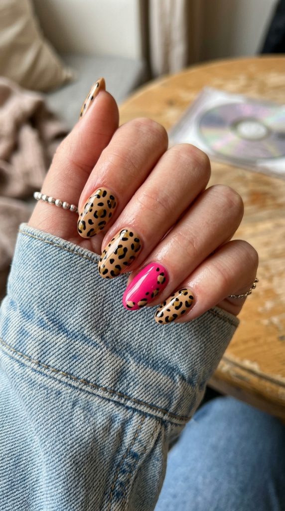 Y2K cheetah print nails with a pink accent nail
