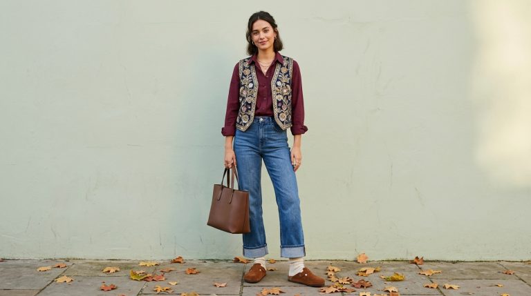 Cuffed jeans and a burgundy shirt with brown clogs and ribbed socks