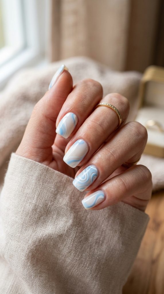 Baby blue and white swirl nails