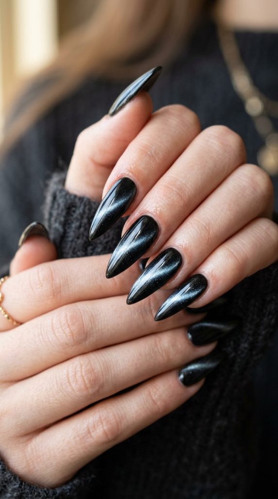 Black cat-eye shimmer stiletto nails
