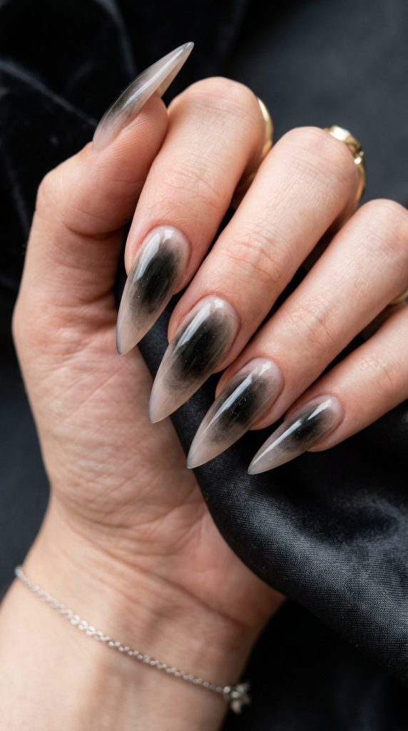 Black stiletto nails with a blood-red accent