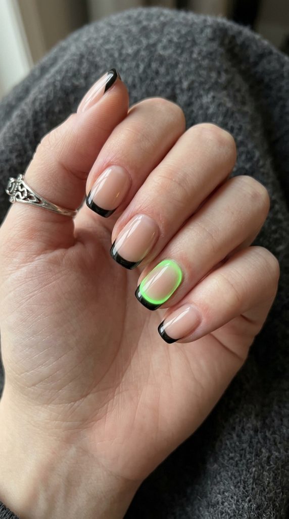 Black French nails with one green accent