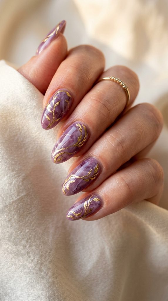 Gold foil swirl nails on a purple base
