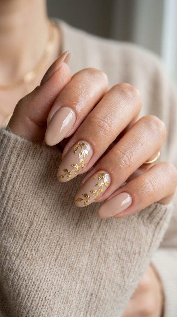 Nude manicure with gold metallic leaf detail