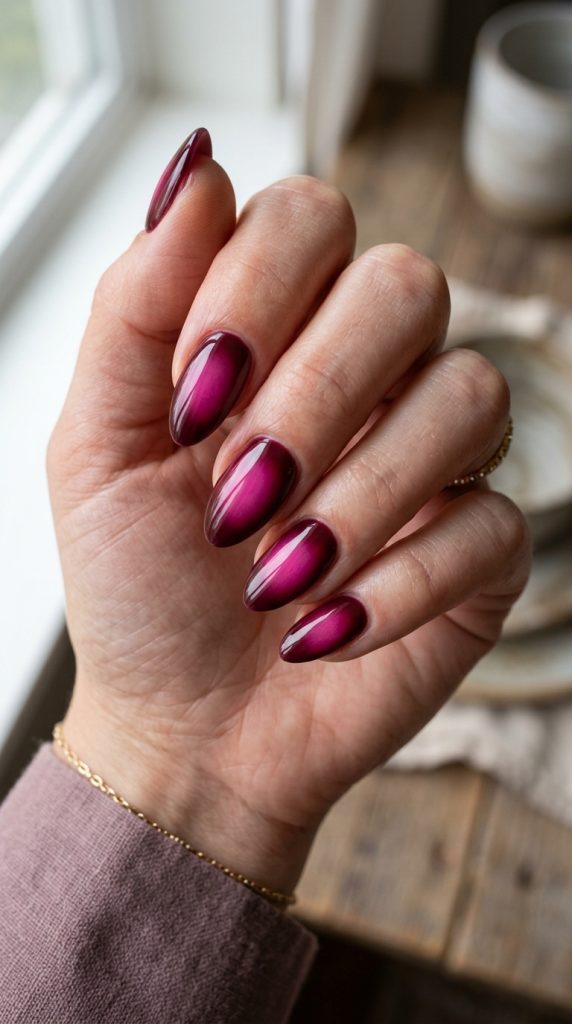 Two-tone aura nails with a burgundy base and pink center