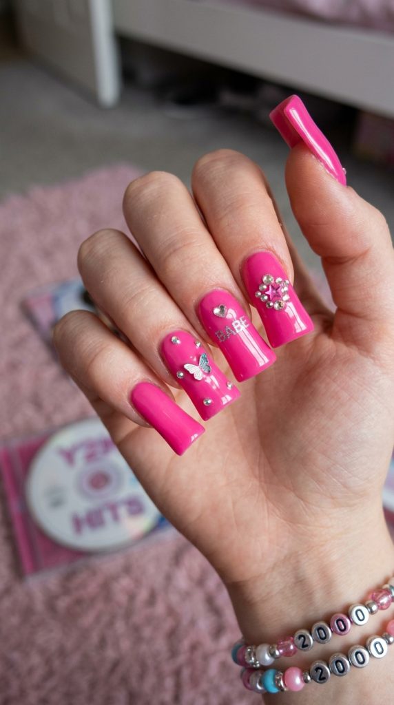 Y2K duck nails flaring wide at the tips in glossy pink
